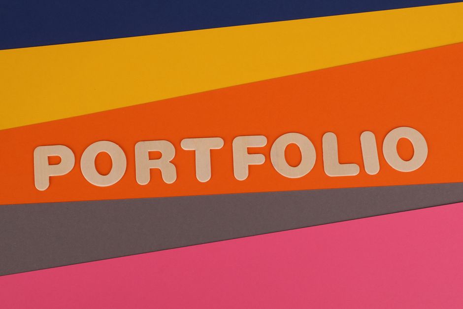 A vibrant multicolored background featuring the text 'PORTFOLIO' in pink font on colorful paper.